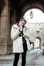 Young pretty stylish teenage girl outside on city street fancy fashion dressed drinking milk shake Royalty Free Stock Photo