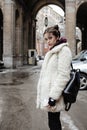 Young pretty stylish teenage girl outside on city street fancy fashion dressed drinking milk shake Royalty Free Stock Photo