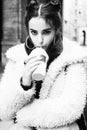 Young pretty stylish teenage girl outside on city street fancy fashion dressed drinking milk shake Royalty Free Stock Photo