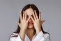 young pretty surprised woman covering her eye by hand Royalty Free Stock Photo