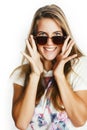 Young pretty teen blond girl posing cheerful isolated on white background wearing sunglasses, lifestyle people concept Royalty Free Stock Photo