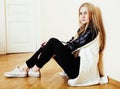 Young pretty teenage blond girl sitting on floor at home despair Royalty Free Stock Photo