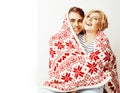 Young pretty teenage couple at Christmas time warming in red dec Royalty Free Stock Photo