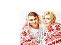 Young pretty teenage couple at Christmas time warming in red dec Royalty Free Stock Photo