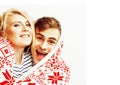 Young pretty teenage couple at Christmas time warming in red dec Royalty Free Stock Photo