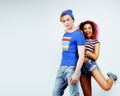 Young pretty teenage couple, hipster guy with his brasilian girlfriend happy smiling isolated on background, lifestyle Royalty Free Stock Photo