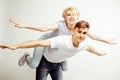 Young pretty teenage couple, hipster guy with his girlfriend happy smiling and hugging on white background Royalty Free Stock Photo