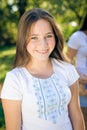 Young pretty teenage girl having fun on green summer outdoors