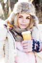 Young pretty teenage hipster girl outdoor in winter snow park ha Royalty Free Stock Photo