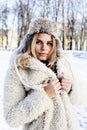 Young pretty teenage hipster girl outdoor in winter snow park having fun drinking coffee, warming up happy smiling Royalty Free Stock Photo