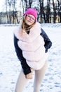 Young pretty teenage hipster girl outdoor in winter snow park having fun drinking coffee, warming up happy smiling Royalty Free Stock Photo