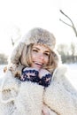 Young pretty teenage hipster girl outdoor in winter snow park having fun drinking coffee, warming up happy smiling Royalty Free Stock Photo