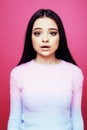 Young pretty teenage woman emotional posing on pink background, fashion lifestyle people concept Royalty Free Stock Photo