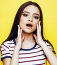 Young pretty teenage woman emotional posing on yellow background, fashion lifestyle people concept Royalty Free Stock Photo