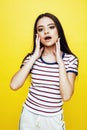 Young pretty teenage woman emotional posing on yellow background, fashion lifestyle people concept Royalty Free Stock Photo