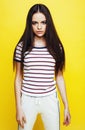 Young pretty teenage woman emotional posing on yellow background, fashion lifestyle people concept Royalty Free Stock Photo