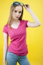 Young pretty teenage woman emotional posing on yellow background, fashion lifestyle people concept Royalty Free Stock Photo