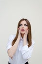 Young thoughtful businesswoman looking up in amazement Royalty Free Stock Photo