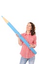 Young pretty woman with big blue pencil Royalty Free Stock Photo