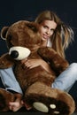 Young pretty woman with big teddy bear Royalty Free Stock Photo