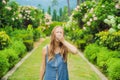 Young pretty woman blowing nose in front of blooming tree. Spring allergy concept Royalty Free Stock Photo