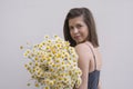 Young pretty woman with bouquet of white chamomile daisy flowers on white background Royalty Free Stock Photo