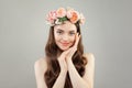 Young pretty woman with clear skin, healthy hair and flowers wreath