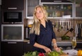 Young pretty young woman cooking salad in kitchen Royalty Free Stock Photo