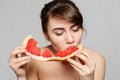 Young pretty woman or cute girl with long hair holds grapefruit fruit slice Royalty Free Stock Photo