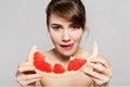 Young pretty woman or cute girl with long hair holds grapefruit fruit slice Royalty Free Stock Photo