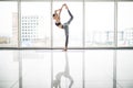 Young pretty woman doing stretching exercise on yoga mat. Fitness, sport, training and lifestyle concept. Royalty Free Stock Photo