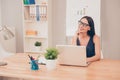 Young pretty woman dreaming in office instead of doing her job Royalty Free Stock Photo