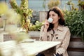 Young pretty woman drink coffee in cup outdoor Royalty Free Stock Photo