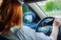 Woman drives car. Female hands on the steering wheel of a car while driving.