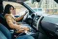 young pretty woman driving car while drinking cup of coffee Royalty Free Stock Photo