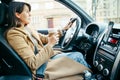 young pretty woman driving car while drinking cup of coffee Royalty Free Stock Photo