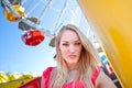 Young pretty woman in front of a Ferris wheel Royalty Free Stock Photo