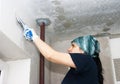 Young pretty woman geting plaster wall