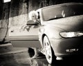 Young pretty woman getting out of sport car Royalty Free Stock Photo