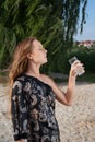 Young pretty woman with glass with water on beach Royalty Free Stock Photo