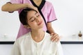 Young pretty woman has thai massage. Closeup of neck stretching. Calm atmosphere. Concept of serene spa treatments Royalty Free Stock Photo