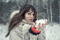 Young pretty woman having fun in the winter forest with snow in hands Royalty Free Stock Photo