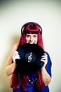 Young pretty woman with headphones biting vinyl record Royalty Free Stock Photo