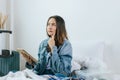 Young pretty woman hipster traveler thinking and checking and packing clothes into suitcase Royalty Free Stock Photo