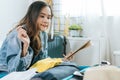 Young pretty woman hipster traveler thinking and checking and packing clothes into suitcase for holiday vacation Royalty Free Stock Photo