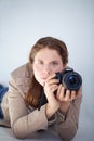 A woman with a canon DSLR camera prepares to take a photo