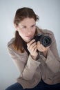 A young pretty woman holding a canon DSLR