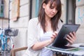 Young pretty woman holding Ipad looking away. Royalty Free Stock Photo