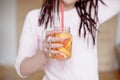 Young pretty woman holding mason jar with lemonade.