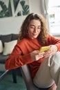 Young pretty woman using smartphone holding cell phone at home. Royalty Free Stock Photo